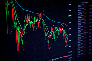 Stock charts on the monitor close up. Finance and stock exchange concept.